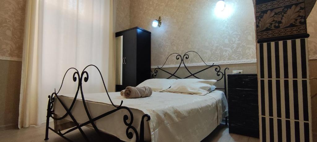 a bedroom with a bed and a dresser at Hidden Rooms Freedom Square in Tbilisi City
