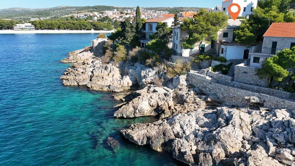 a group of houses on a rocky island in the water at Apartments Ziva in Primošten