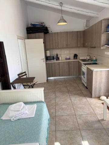 a kitchen with a table and a kitchen with a refrigerator at Οικία Χωρας Κυθνου in Kithnos