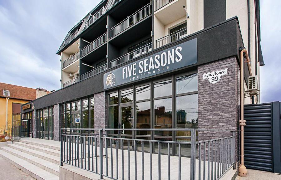 a large building with a sign on the side of it at Five Seasons apartments in Odesa