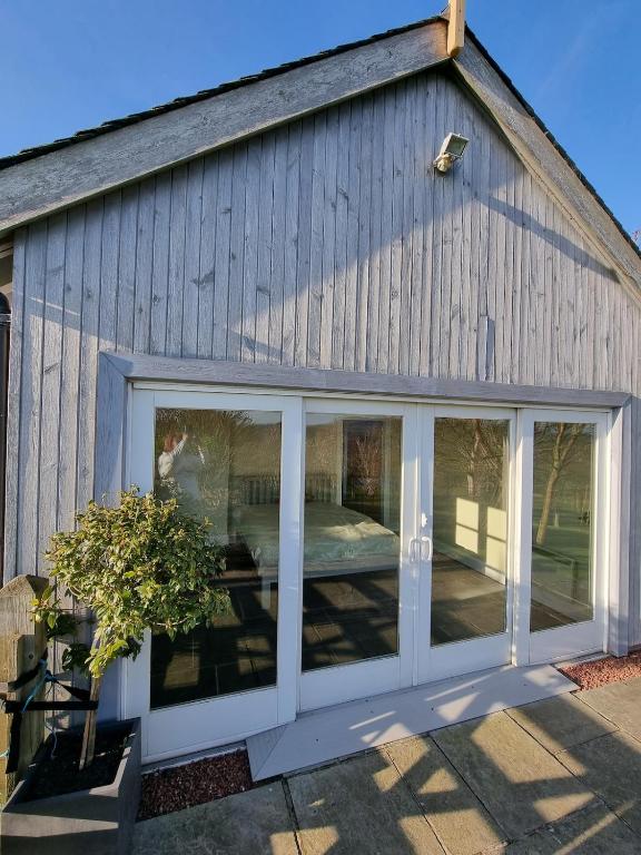 a large sliding glass door on a building at Huntshaw Stables in Earlston