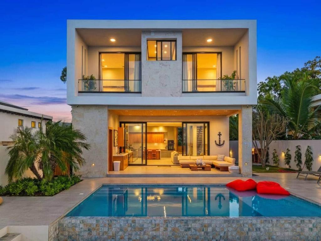 a house with a swimming pool in front of it at Beachfront Modern Villa with Pool AZURE in Punta Rucia