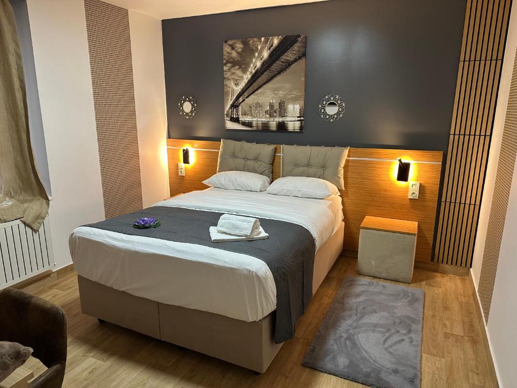 a bedroom with a large bed in a room at Hôtel Le Prince, Poitiers Gare in Poitiers