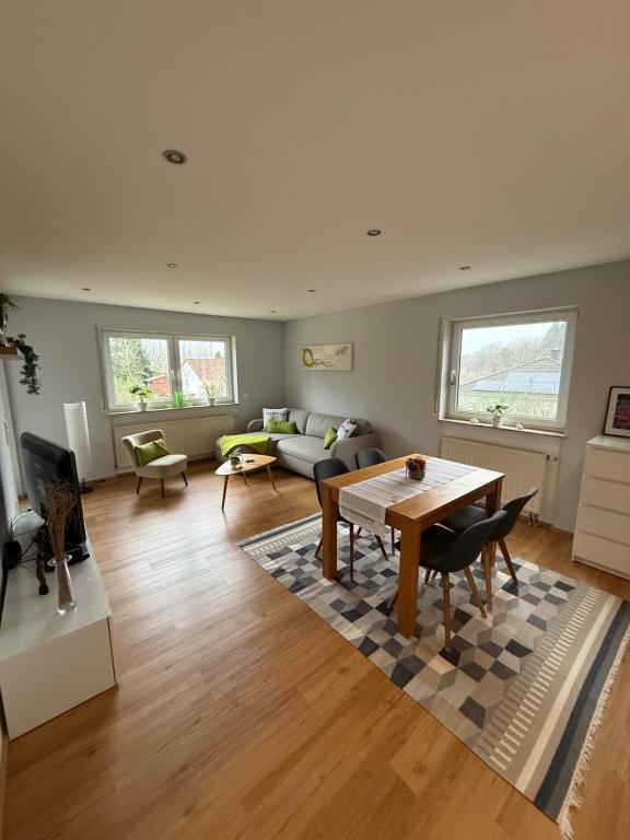 a living room with a table and a couch at Ferienwohnung Carina in Losheim