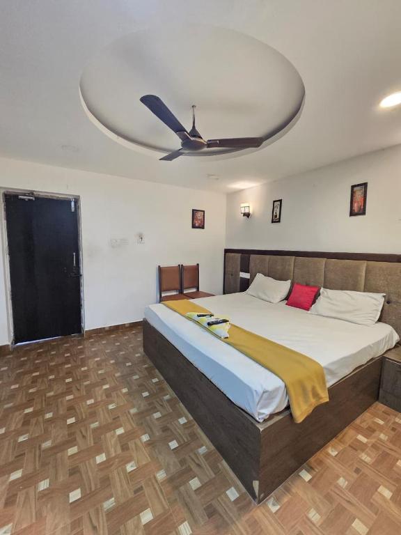 a bedroom with a large bed with a ceiling at Bluebell castle in Mahabalipuram