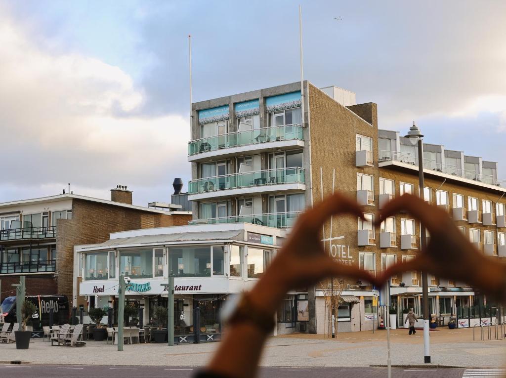 a view of a building from a window at Hotel Noordzee in Katwijk aan Zee