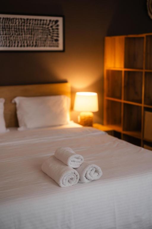 a hotel room with two rolled towels on a bed at Fly Residence 2 in Arad