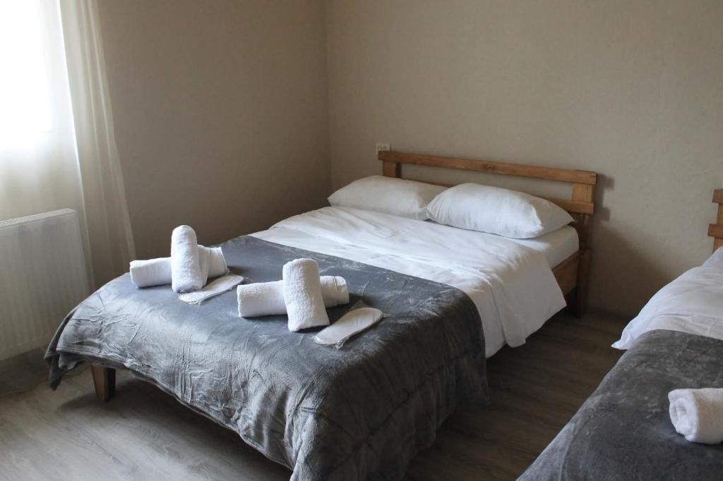 a bedroom with two beds with towels on it at Guest House Aspindza in Aspindza