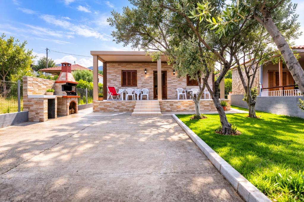 a home with a stone house with a fireplace at Sampa Villa in Asprovalta