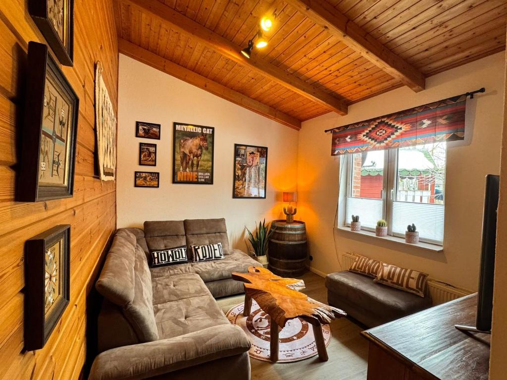 a living room with a couch and a table at Tiny Rooster Lodge in Alt Duvenstedt