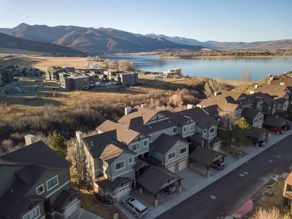 an aerial view of a subdivision of houses next to a lake at Lakeside Funscape LS33 Ski & Snowboard Hot Tub in Huntsville