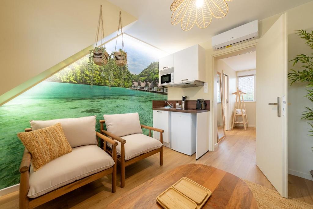 a living room with a large painting on the wall at Air Nomad • Bali in Valenciennes