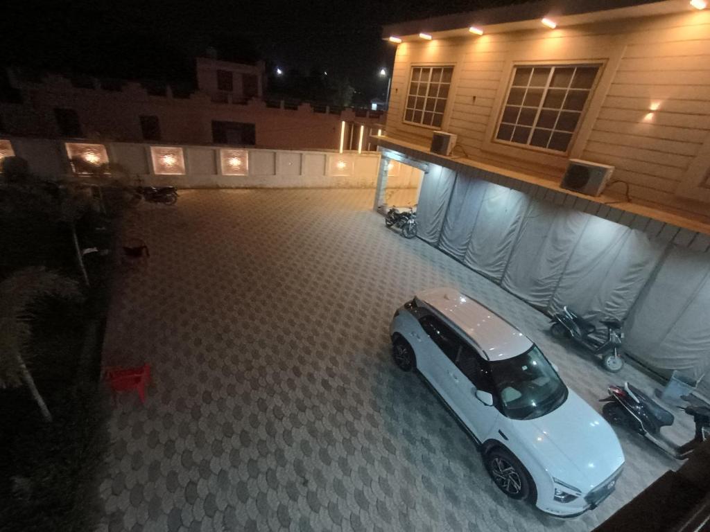 a car parked in a parking lot next to a building at Prince Vatika in Alwar