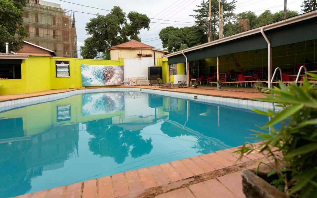 an empty swimming pool in front of a building at Admiral Hotel and Spa Kampala in Kampala