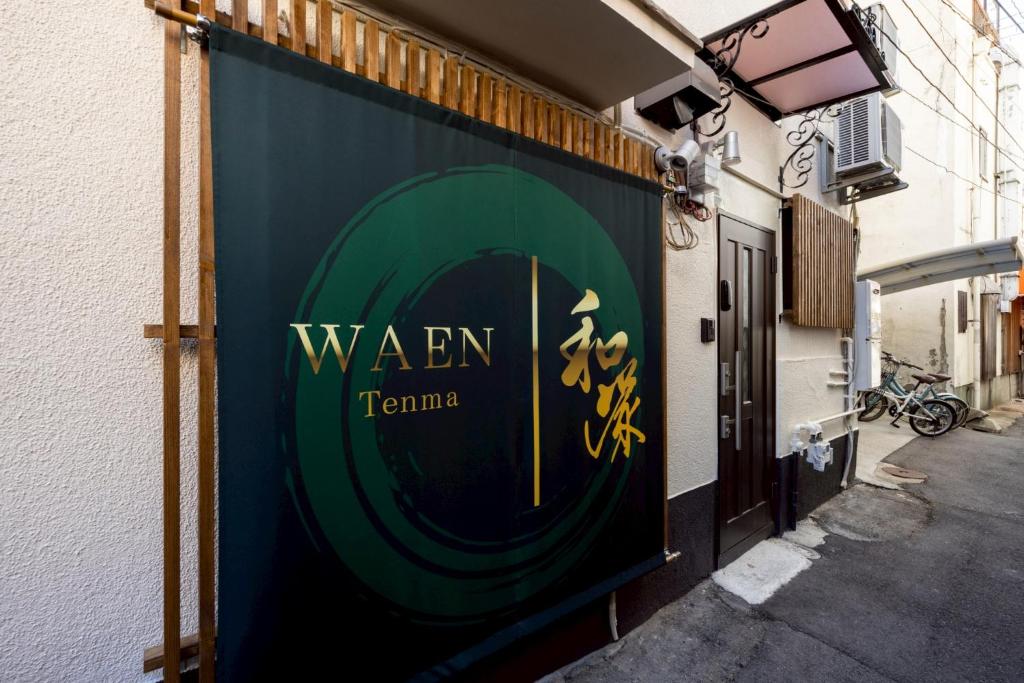 a sign on the side of a building at Waen Tenma in Osaka