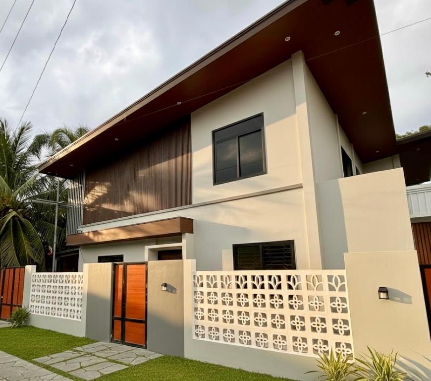 a house with a fence in front of it at La Residencia Homestay in Digos