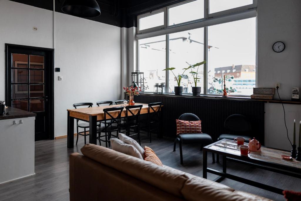 a living room with a couch and a table at BBgebouw39 - op de Rijkswerf in Den Helder