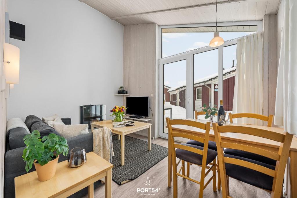 a living room with a couch and a table at Ferienhaus Brocken - Sankt Andreasberg im Harz in Sankt Andreasberg