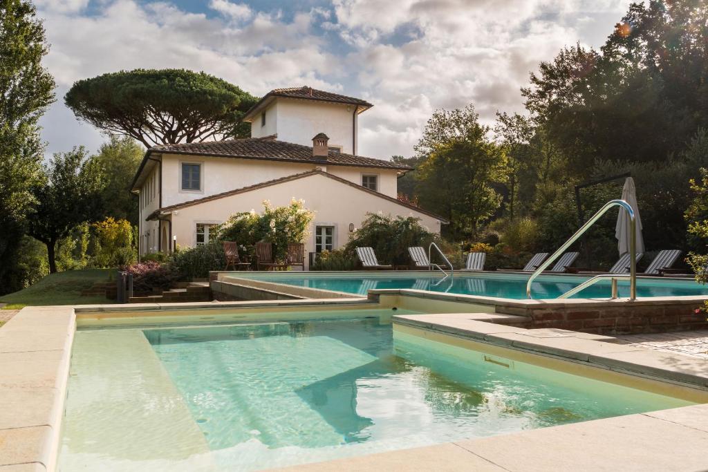 a swimming pool in front of a house at Villa Valle, Villa Saletta Wine Estate in Forcoli