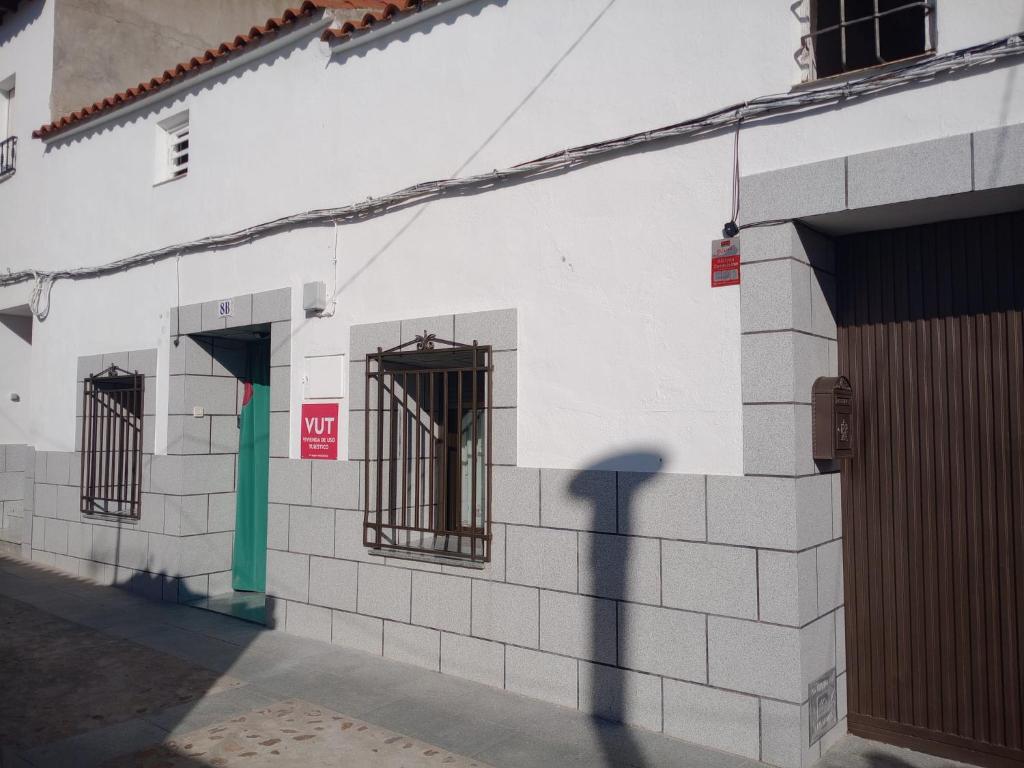 a building with barred windows on the side of it at Los Tres Lobitos in Orgaz