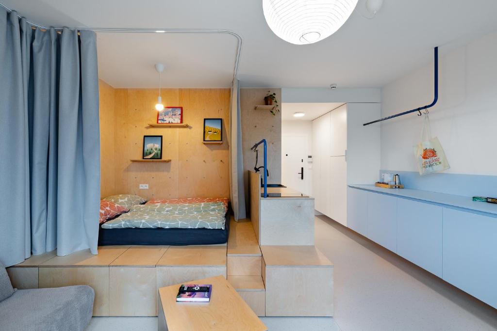 a room with a bed and a couch and a table at Super apartmán - self check in, free private parking, balcony in Banská Bystrica