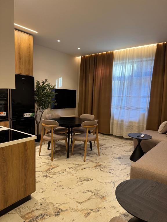 a living room with a table and chairs at Selez Aparthotel & Residence in Durrës