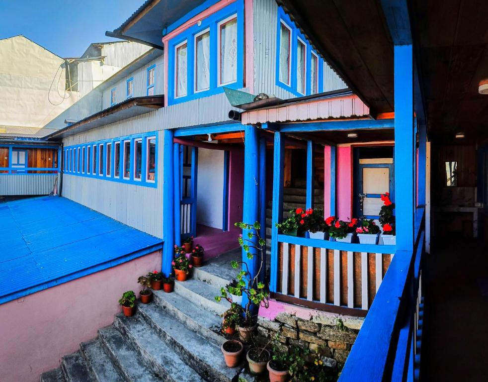 a colorful house with potted plants on the porch at Sagun's Place in Phāphlu