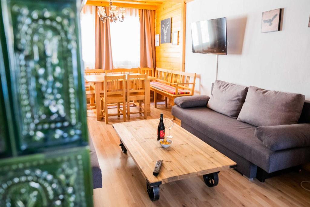 a living room with a couch and a table at Four Seasons Lodge in Lackenhof