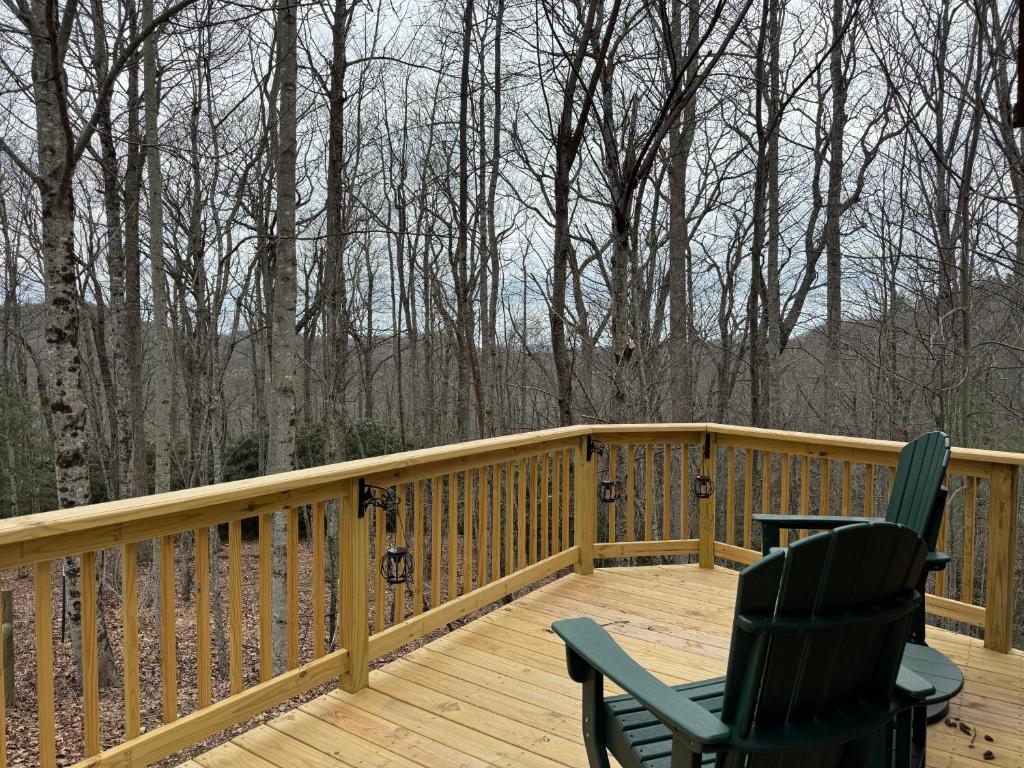 two chairs on a wooden deck with trees in the background at Quiet Mountain Top, Pet Friendly, Private Deck in Boone