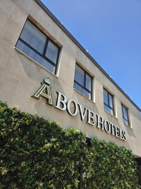 a building with a sign on the side of it at Above Hotels in Burnley