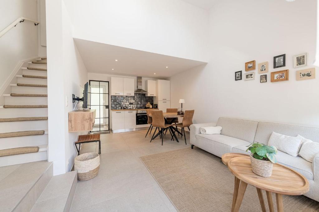a living room with a couch and a table at Lovely Duplex Axime with beautiful hill views - Malmedy in Malmedy