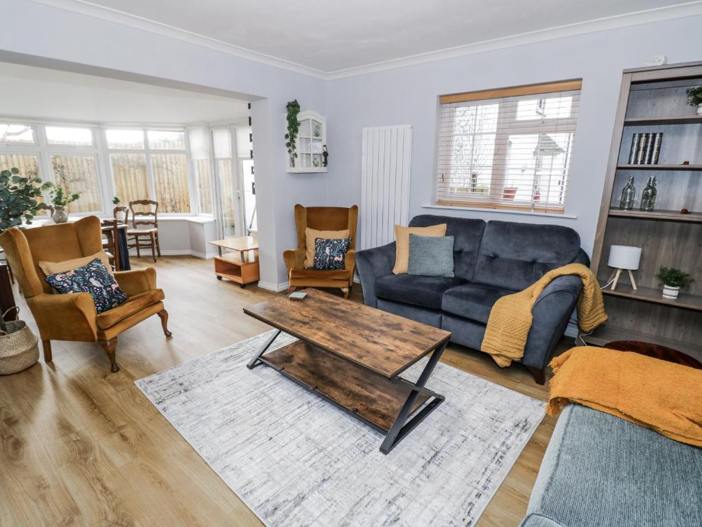 a living room with a couch and a table at 3 Leycester Court in Warwick
