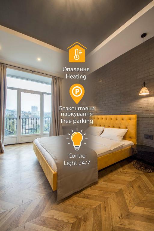 a bedroom with a bed with a sign on the wall at Idea Design Apart-Hotel Prorizna in Kyiv
