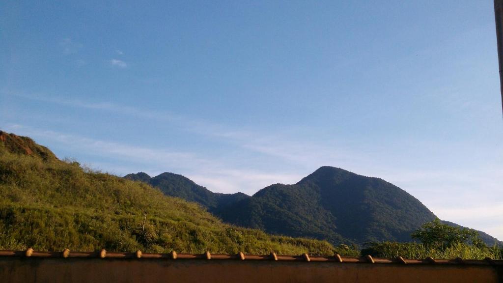 a view of a mountain range with a train at Apartamento da Vanda in Ubatuba