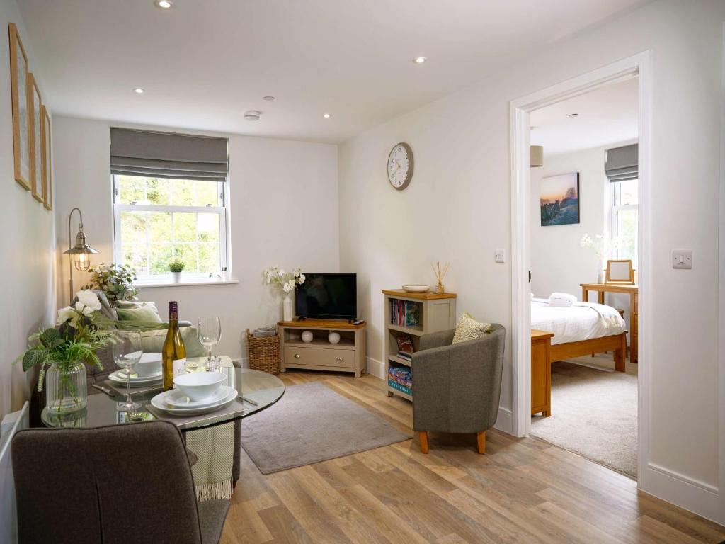 a living room with a table and a bedroom at Rock Mill 1 Bed Apartment 36 in Stony Middleton