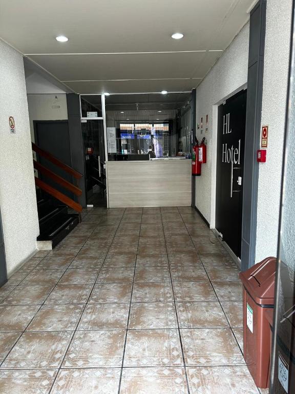 an empty hallway of a building with ailed floor at HL Hotel in Pelotas