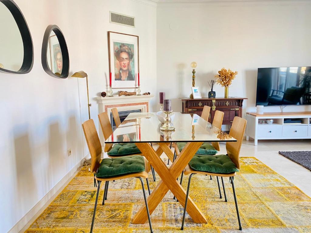 a dining room with a glass table and chairs at Colinas do Cruzeiro Residence Odivelas in Odivelas