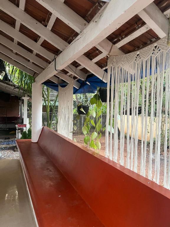 a hammock hanging from a porch at The Wilderness Studio! in Anjuna