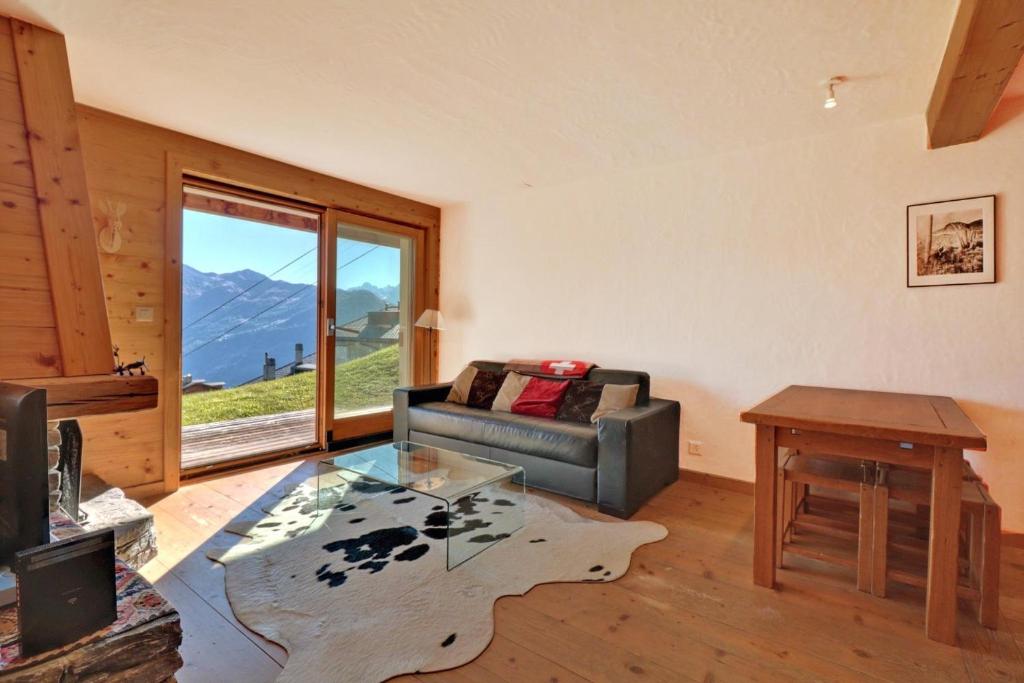 a living room with a couch and a table at Altiplano 003 in Verbier