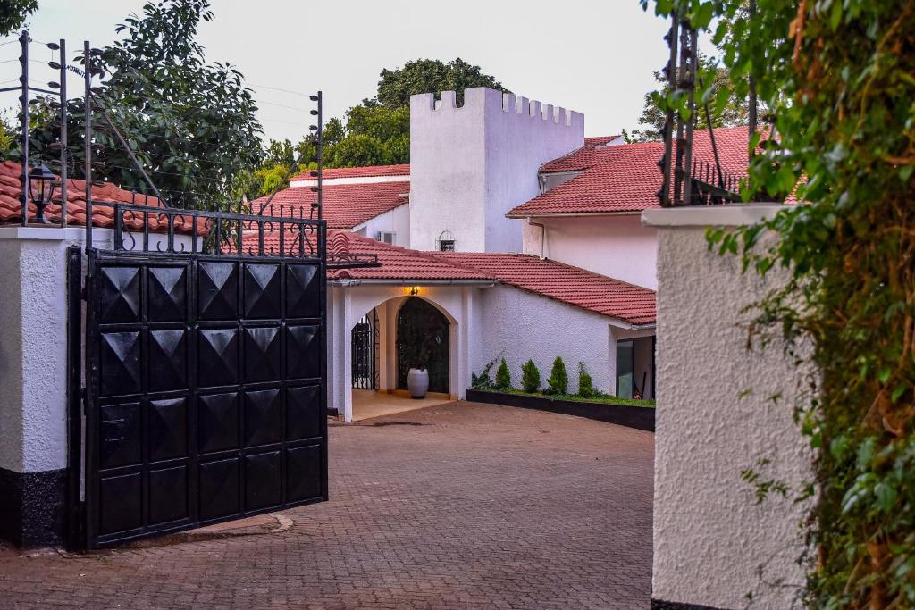 a large black garage door in front of a house at Cozy Stead Hotel - Haven House, Gigiri in Nairobi