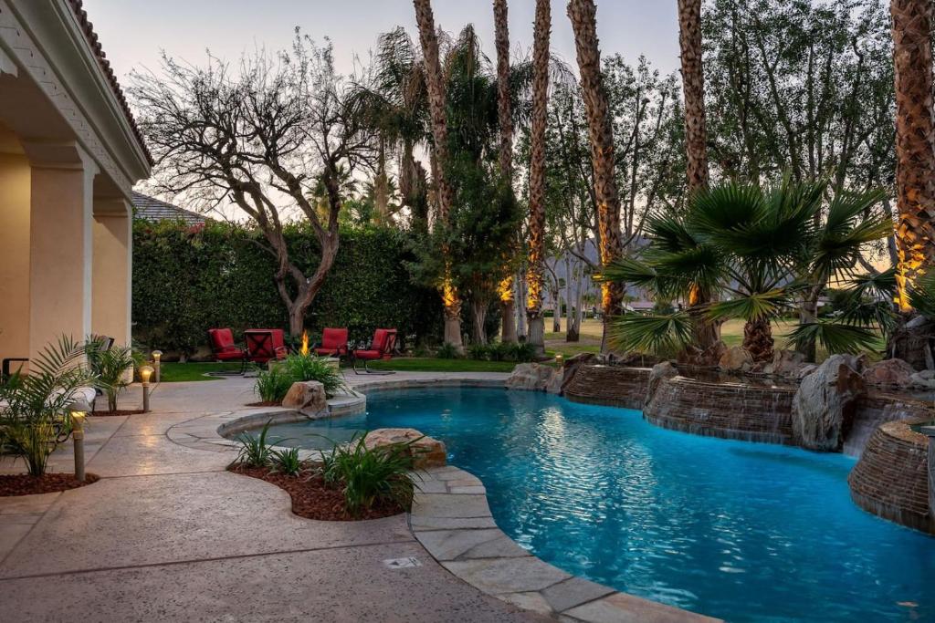 a swimming pool in a yard with palm trees at The Fourteen at PGA West in La Quinta