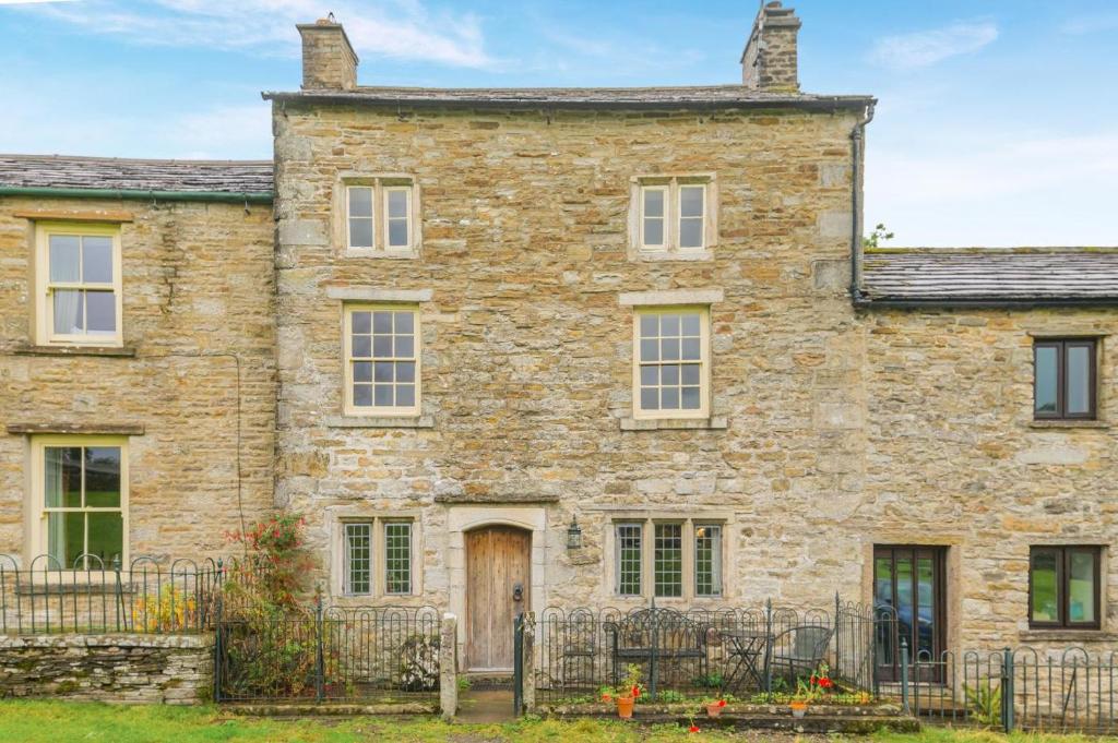 an old stone house with a gate in front of it at 2 Bed in Hawes oc-c33371 in Hawes