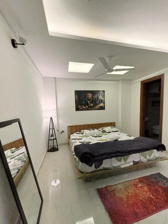 a bedroom with a bed and a ceiling fan at B&A Stays in Dehradun