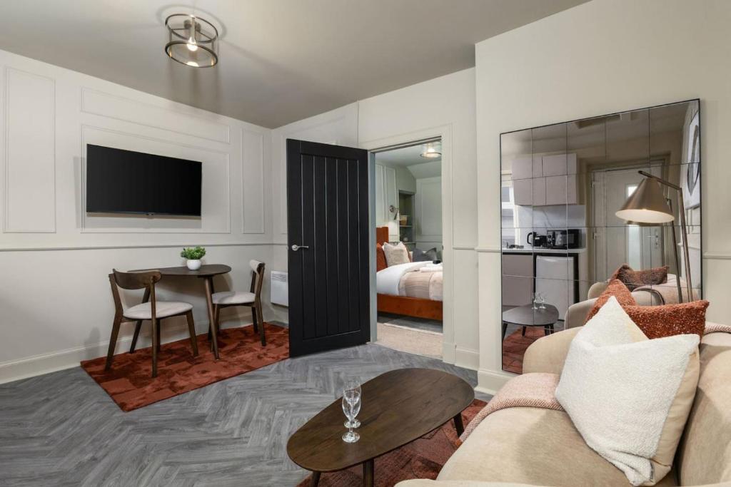 a living room with a couch and a table at Caledonia Suite by The Wallace Monument in Stirling