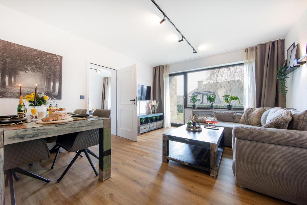 a living room with a couch and a table at Burgberg City Apartment in Daun