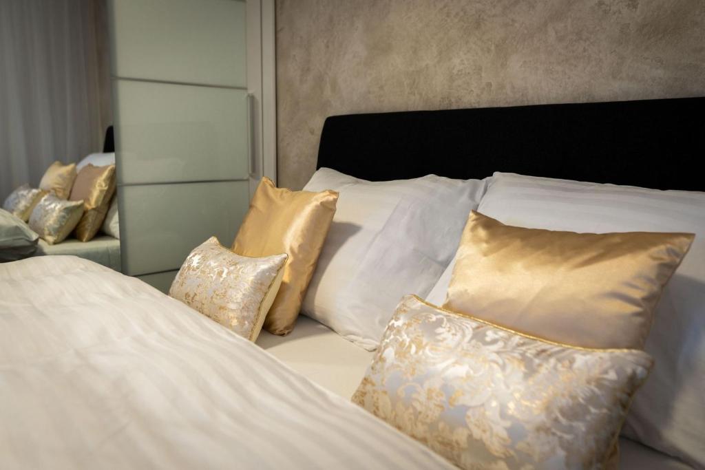 a bedroom with two beds with pillows and a mirror at Apartmán u Pivovaru in Rožnov pod Radhoštěm