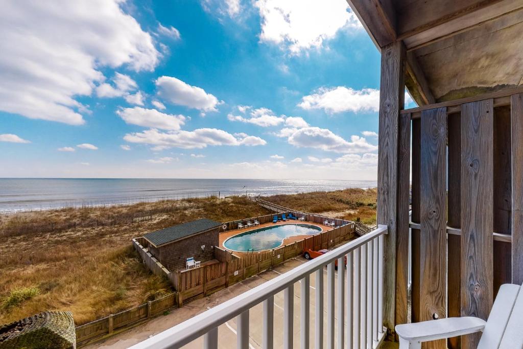 a view of the ocean from the balcony of a house at Oceanfront, dog-friendly condo with ocean view, pool & central AC in Hatteras
