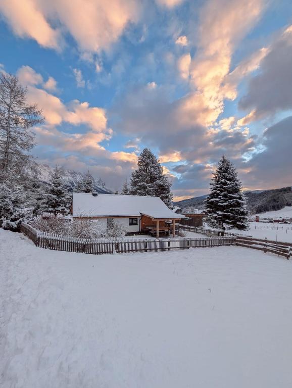 a house in the snow with a snow covered yard at Strausshaus in Gröbming