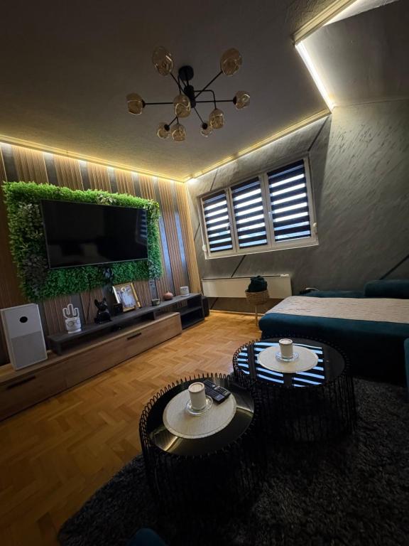 a living room with two tables and a couch at Apartman 23 in Belgrade