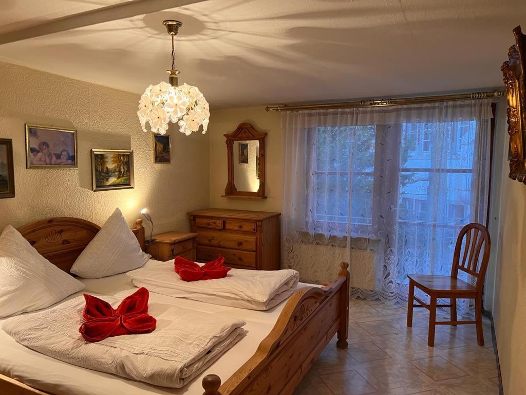 a bedroom with a bed with red bows on it at seeglueck Retro Am Münster in Konstanz